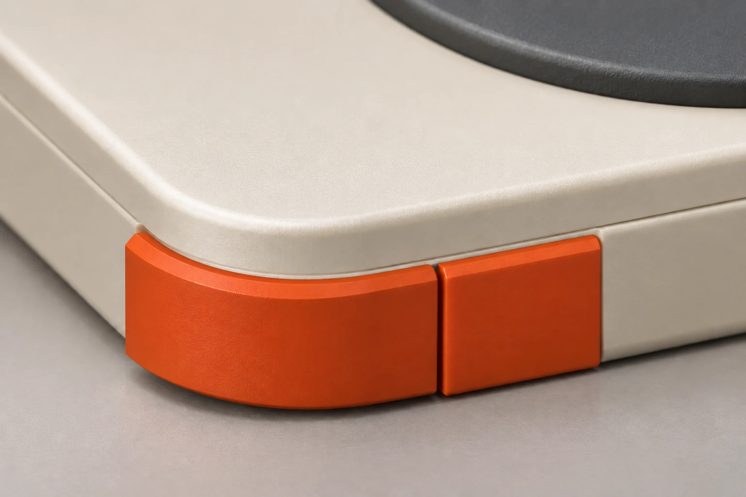 Close-up of orange buttons along the edge of the cream Pokkio case