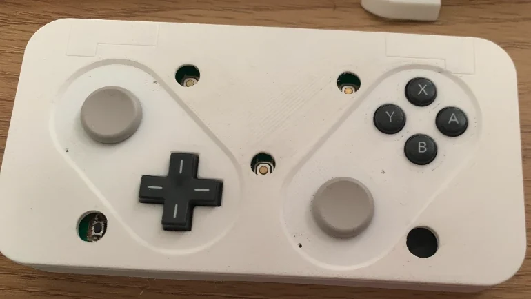 3D-printed controller case fitted with analog pads, a D-pad and ABXY buttons